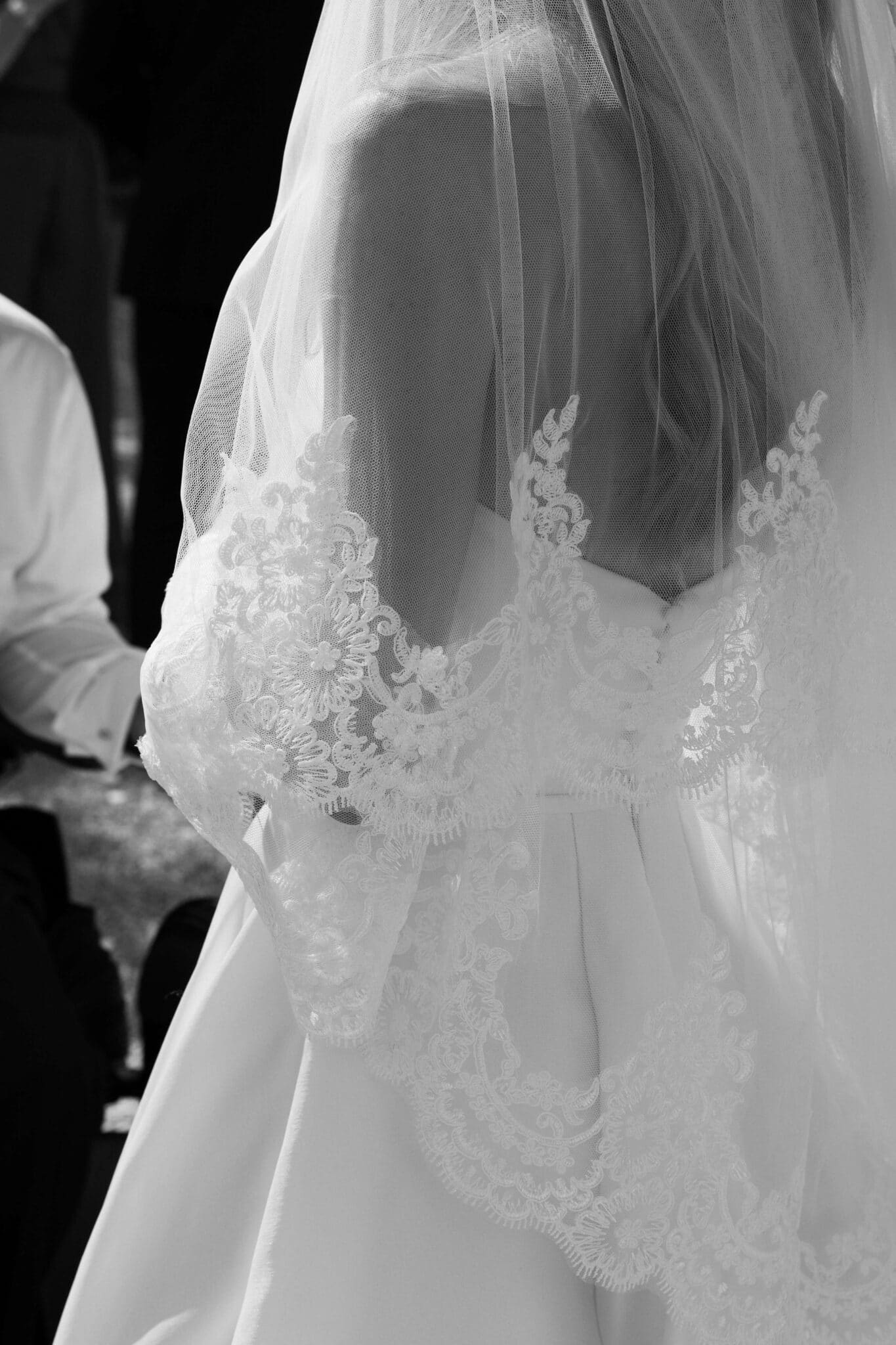 Elegant close-up detail of the bride's intricate lace back — timeless, editorial wedding photography at a luxury destination wedding near Bordeaux France