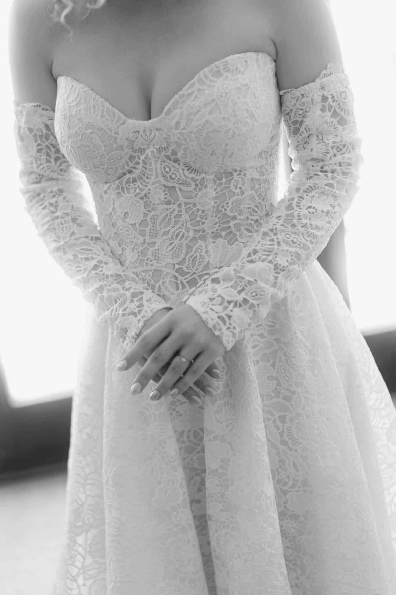 Black and white close-up of an intricate lace wedding gown at a luxury Munich wedding